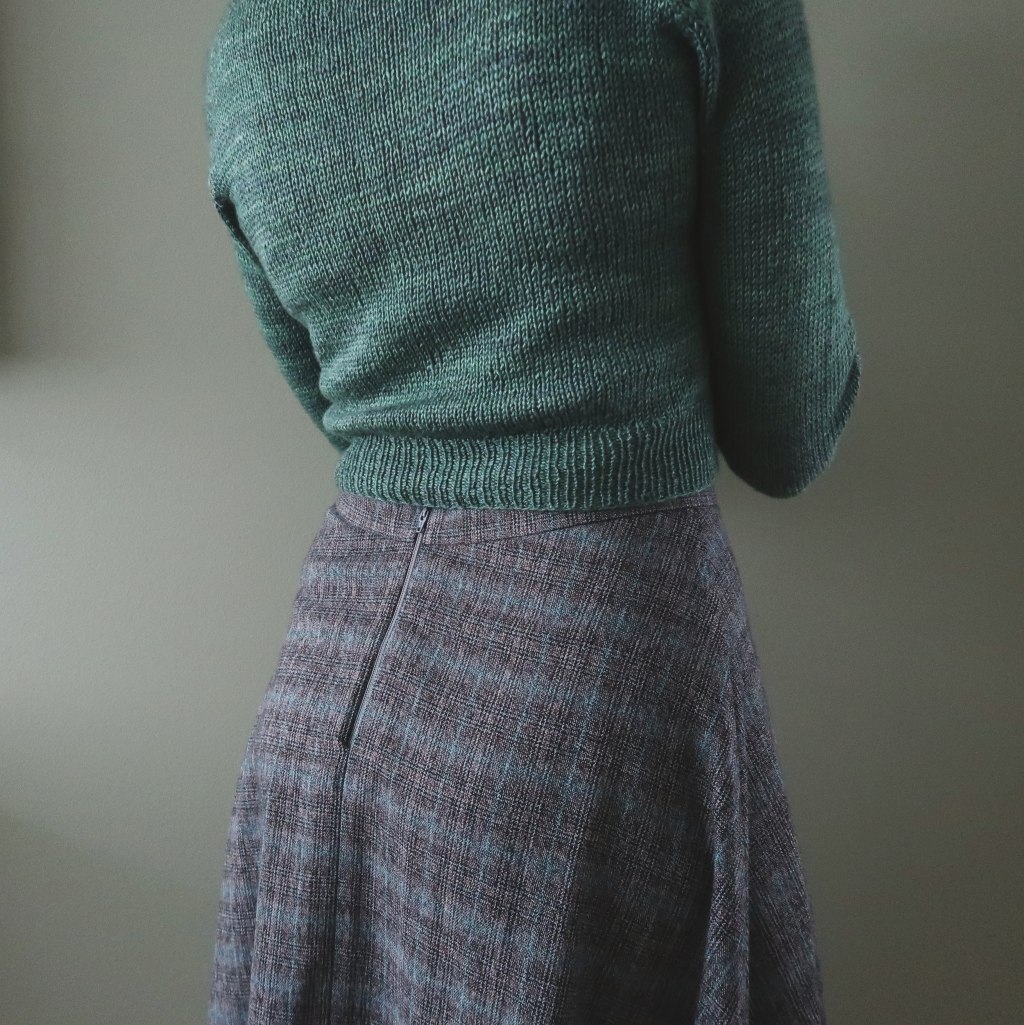 A close shot of the back of the skirt, shewing the grey zipper.