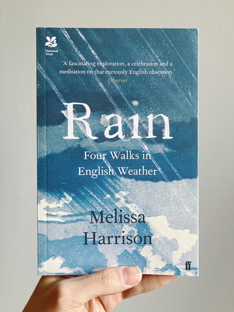 The book "Rain: Four Walks in English Weather." The cover art features a sky with dark clouds up above, but lighter skies and white clouds peeking out from behind down below. Streaks of rain shoot down in diagonal lines.