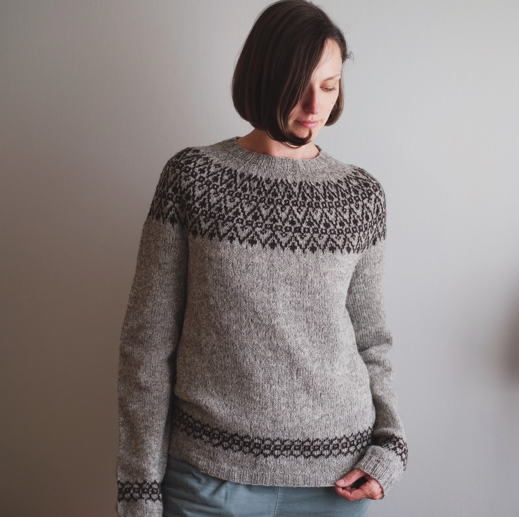 A wider shot of Dianna wearing the sweater. The hem and cuffs also feature colorwork.