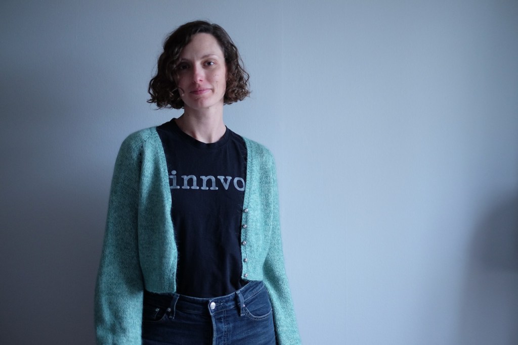 Dianna wears the cropped minty cardigan unbuttoned over a black t-shirt and jeans.